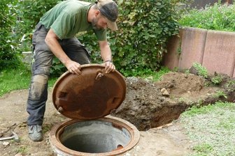 Kampf gegen Radon: Dieser Brunnen soll Kinder in Zschopau schützen - Henrik Reichel montiert den Schachtdeckel auf die Radonfalle, in der sich das radioaktive Gas sammeln und abgeleitet werden soll. 