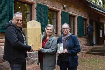 Lutherweg: Was enthält der neue Pilgerschrank auf dem Rochlitzer Berg? - Steffen Schnabel (von links), Anja Schwulst und Ilke Schulz bringen den neuen Pilgerschrank am Geoportal an.