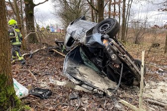 Mann ohne Führerschein fährt BMW zu Schrott – Straße von Zwickau nach Crimmitschau wieder frei - Der völlig verbeulte BMW kam in einem kleinen Waldstück zum Stehen – schräg auf dem Dach liegend.