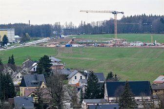 Mehr Familienwohnungen für Neukirchen? Pläne für neues Wohn- und Gewerbegebiet nehmen Gestalt an - Blick auf die Baustelle der Grundschule Neukirchen. Unterhalb, an der Stollberger Straße, soll ein Wohngebiet entstehen.