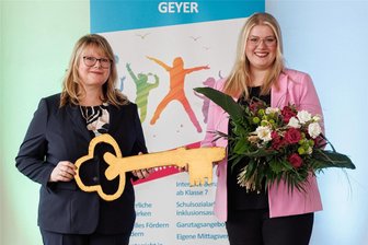Meilenstein im Erzgebirge: In Geyer geht eine neue Oberschule offiziell an den Start - Madeleine Schlosser (links), Geschäftsführerin des Bildungsträgers IAJ, übergibt den symbolischen Schlüssel an Nancy Schlosser, die Leiterin der neuen Oberschule in Geyer.