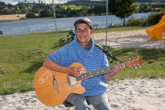 Mit Gitarre, Gott und guter Laune: Das ist die Frau hinter der Zeltplatzmission an den Talsperren im Vogtland - So kennt man Ulrike Schmidt an den Talsperren Pirk und Pöhl - singend, die Gitarre in Händen.
