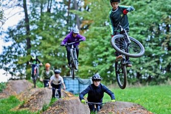 Mit kleinen Sprüngen zum Dirtpark - Der elfjährige Nick Nötzold (vorn) gehört zu etwa zehn wilden Bikern, die in Bernsdorf Erde für eine sogenannte Line geschaufelt haben.