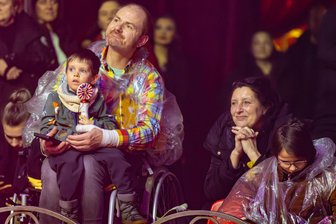 Mit Regenschirm und Cape in der ersten Reihe: Weihnachtszirkus Chemnitz lockt mit spektakulärer Wassershow - Für einen Moment den harten Alltag vergessen - Silvio Neßmann mit seiner Begleitung und Enkel Lion.