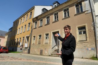 Neubau-Plan für Kirchenzentrum in Auerbach stockt: „Acht Millionen Euro sind chancenlos“ - Für Pfarrerin Nikola Schmutzler ist das Gemeindezentrum Herzenssache. Das Pfarramt (gelbe Fassade) soll modernisiert, das Haus am Kirchplatz 6 abgerissen und durch Neubau ersetzt werden