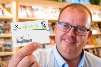 Neue Abgabe: Olbernhau bittet Besucher zur Kasse, bietet aber auch etwas - Udo Brückner, er ist in Olbernhau für den Tourismus verantwortlich, zeigt ein Muster der Gästekarte.