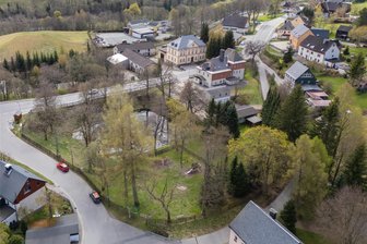 Neue Rettungswache am Fichtelberg: Geplanter Standort löst Ärger aus - Für die neue Oberwiesenthaler Rettungswache ist das parkähnliche Spielplatzgelände vor dem Teich ins Auge gefasst worden. Es liegt an der Emil-Riedel-Straße. Nur wenige Meter weiter verläuft die B 95 (hinten).