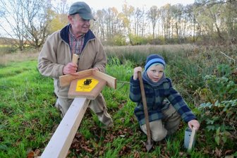 Neue Schilder markieren schützenswerte Fläche bei Reumtengrün - Ulrich und Levi Badstübner beim Aufstellen eines Naturschutzschildes am Ortsrand von Reumtengrün.