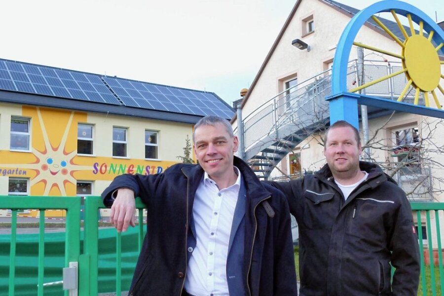 Neue Turnhalle in Drebach bekommt Solardach mit 216 Modulen - Volker Weber (l.) und Sören Rösch vor der Drebacher Kita "Sonnenstrahl", auf der die Bürger-Energie eine PV-Anlage betreibt. 