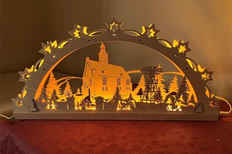 Neuer Schwibbogen für Obercrinitz: LED-Lichter lassen Dorfkirche leuchten - Die St.-Johannis-Kirche Obercrinitz ist das Motiv des Schwibbogens, den die Kirchgemeinde hat fertigen lassen.