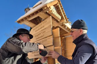 Neues Schmuckstück im Erzgebirge weist Weg zu Basaltnischeln und Tischkastenscheißern - Roland Erdmann und Uwe Furkert beim Aufstellen des Wegweisers in Neudorf.