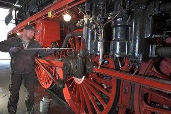 Nostalgische Zugreisen ab Nossen nicht nur für Bahnfreaks - Die IG Dampflok Nossen und der Förderverein Zellwaldbahn organisieren auch 2025 wieder Sonderfahrten. Dafür wird eine Dampflok flott gemacht. Im Bild Henry Franz beim Ölen der Stangenlager. was vor jeder Schicht nötig ist.