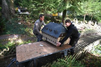 Oederan: Die Welt der erzgebirgischen Miniaturen geht in die Winterpause - Bilder von der großen Häuserabfahrt - Michael Keller (links) und Christopher Müller demontieren das Gasthaus Grüne Tanne.