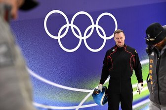Olympiasieger Francesco Friedrich im Erzgebirge zu Gast - Olympische Winterspiele 2026: Francesco Friedrich steht vor den Olympischen Ringen.