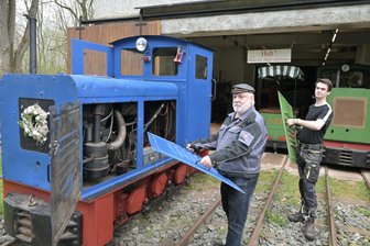 Osterfahrten mit ehemaliger Feldbahn im Erzgebirge: Mit viel Aufwand in die neue Saison - Matthias Stein (65 Jahre) und der 21-jährige Sebastian Jung von der Arbeitsgruppe Feldbahn vorm Lokschuppen an einer blauen Lok der Bauart Ns2f. Die Arbeitsgruppe sucht Nachwuchs.