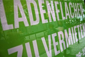 Pop-up-Event als Wiederbelebungsversuch für leere Stollberger Läden - Passanten spiegeln sich in einer Scheibe eines leerstehenden Ladengeschäfts.