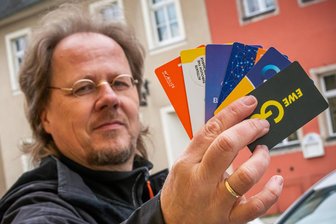 Preischaos an öffentlichen Ladesäulen: Zschopauer Grüne-Stadtrat frustriert - Niels Sigmund mit seinem Lade-Karten-Spiel.