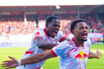 RB Leipzig und der Wetterumschwung in Heidenheim - Angreifer Lois Openda (rechts) erzielte den Siegtreffer für die Leipziger und jubelte vor den Fans mit Teamkollege Castello Lukeba.