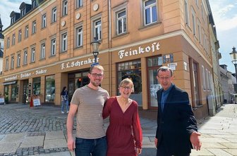 Reichenbacher Schenkerhaus wird Seniorensitz: Bäckerei investiert in Umbau - So sieht Zuversicht aus. Melanie und Thomas Lenk von der gleichnamigen Lengenfelder Bäckerei und Olaf Schwarzenberger von der Volkssolidarität Vogtland vor dem Schenkerhaus - das bald eine große Baustelle ist. Passend zu Lenks Bäckerei- und Café-Angebot im Erdgeschoss soll die Fassade künftig cappuccino-farbig Appetit auf einen Besuch machen.