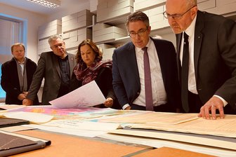 Rohstoff-Versorgung in Europa: Wismut bringt sich wieder für aktive Bergbauprojekte in Stellung - „Kompetenzen wie wenige andere Unternehmen:“ Wismut-Geschäftsführer Michael Paul (rechts) und Staatssekretär Stefan Rouenhoff (2. von rechts) im Rohstoffarchiv am Schacht 371.