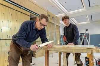 Sachsens neue Forstschule in Auerbach: Bleibt zum Lehrbeginn die Küche kalt? - Stefan Seifert (l.) und Lauren Fischer von der Holzwerkstatt Trommer bauen den Speisesaal der neuen Forstschule in Bad Reiboldsgrün aus. Das ehemaligen Casino der Lungenheilstätte beherbergt Speisesaal und Ausgabeküche, dazu eine Turnhalle und Aufenthaltsräume. 