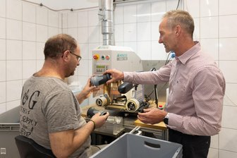 Schichtwechsel im Erzgebirge: Ein Tag mit viel Arbeit und noch mehr Dreckwäsche - Schichtwechsel: Mirko Kretzschmar (l.) aus der Lebenshilfe-Werkstatt hat einen Tag bei Mennekes in Neudorf gearbeitet. Werkstattleiter Steffen Helbig hat ihn dort besucht.