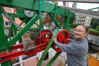 Schlammschlacht vor dem Vergnügen: Gersdorf bereitet seine Kirmes vor - Riesenrad-Inhaberin Antje Bretschneider baut ihre „Russische Schaukel“bei straffem Nieselregen auf. Trotzdem schaut sie optimistisch aufs Wochenende.