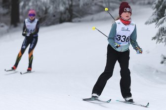 Skilanglauf: Organisatoren verlegen Rehhübellauf von Grünbach nach Mühlleithen - Hier läuft Bailey Ann Echtner (VSC Klingenthal), im Hintergrund kommt Lina Tröger (SV Stützengrün) aus der Kurve.