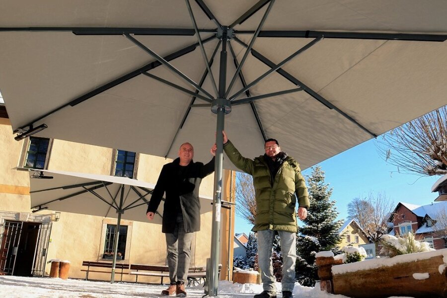 Sonnenschirme feiern in Ellefeld im Advent Premiere - Bürgermeister Jörg Kerber (links) und Jens Seidel schauten sich die beiden Schirme mit Heizstrahlern an, die am Oberen Schloss von Ellefeld aufgestellt worden sind. 