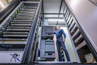 Speicher: Wichtig für die Energiewende – und ein lukratives Geschäft - Robin Anderfuhr von der Zwickauer Firma Ekon arbeitet vor Beginn einer Präsentation in einem mobilen Großspeicher auf Basis gebrauchter Li-Ionen-Batterien. Solche Speicher sollen helfen, Energie aus Solarzellen oder Windkraftanlagen zu speichern.