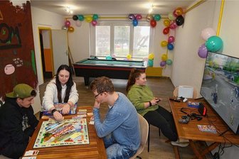 Spiele und Gespräche stehen im neuen Club hoch im Kurs - Am Tag nach der Eröffnung des Rowi-Clubs: Während Moritz mit Leiterin Laura Hessel und Nils eine Runde "Monopoly" spielt, zockt Julia am Computer (von links). Auch Billard und andere Spiele stehen bereit.