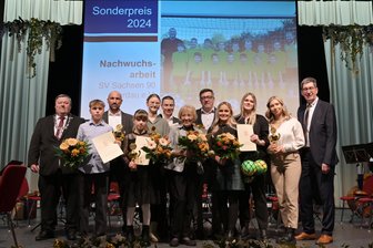 Sportbegeisterung kennt kein Alter: Beim Werdauer Neujahrsempfang stehen eine 10-Jährige und eine 90-Jährige gemeinsam auf der Bühne - Werdaus Oberbürgermeister Sören Kristensen (links) und Hendrik Haertwig (rechts), Geschäftsführer der Stadtwerke Werdau, ehrten die erfolgreichen und engagierten Sportlerinnen und Sportler der Stadt Werdau.