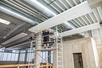 Sporthalle Niederwiesa: Abnahmetermin steht fest - Monteur Patrick Wangel von der Chemnitzer Firma Klempnerwerk reinigt die Deckenheizungselemente.