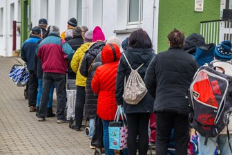 Tafel im Erzgebirge überwindet Personalmangel: Tafelleiterin startet Seniorencafé - Die Tafelkunden warteten am frühen Mittwochnachmittag mit ihren noch leeren Transportbehältern vor der Essensausgabe in Lugau.