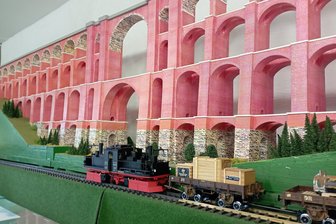 Traditionsverein Rollbockbahn öffnet wieder seine Türen in Oberheinsdorf - Eine Rollbockbahn im Gartenbahnformat vor dem Modell der Göltzschtalbrücke auf dem Oberdeck des Rollbockschuppens.