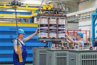 Trafobau Neumark liefert 275.000. Trafo aus - Maßarbeit im Trafobau. Hier wird ein Aktivteil in einen Trafokessel gesenkt.