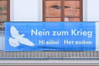 Ukraine: Freiberg sucht dringend Helfer - Das Friedensplakat am Balkon des Schlossplatzquartiers der TU Bergakademie Freiberg. Stadt und Universität zeichnen für mehrere Plakate mit der Losung im Stadtgebiet verantwortlich. 