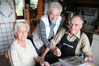 Unglaubliche 105 Jahre: Diese Seniorin aus dem Erzgebirge braucht weder Gehstock noch Brille - Marianne Partenfelder (links) feiert ihren 105. Geburtstag und ist damit die älteste Einwohnerin von Eibenstock. Mit Sohn Christoph und Schwiegertochter Karin stöbert sie in Fotoalben.