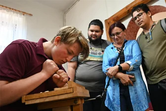 Verein für volkskünstlerische Heimarbeit Penig feiert 110-jähriges Bestehen - Beim Tag der offenen Tür des Vereins für volkskünstlerische Heimarbeit Penig schauen Besucher Jannes Lange beim Schnitzen zu.