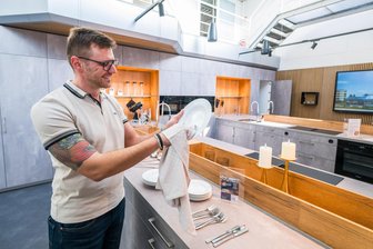 Vom Autohaus zur Eventküche: Das sind die Pläne für Neukirchens neuen kulinarischen Begegnungsort - Neukirchens Bürgermeister Sascha Thamm bereitet eigenhändig die Eröffnung der Eventküche in einem ehemaligen Autohaus vor.