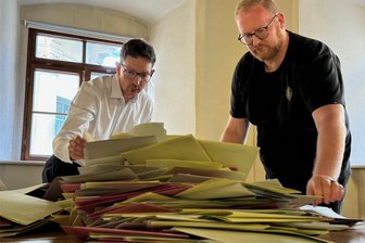 Wahlen im Erzgebirge: AfD dominiert Europawahl – bei den Stadt- und Gemeinderäten sieht es anders aus - Christian Uhlig (l.) von der Stadtverwaltung und das Team vom Wahllokal in der Annaberger Stadtbibliothek haben mit der Stimmauszählung begonnen.