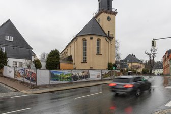 „Wahnsinn“: Kirchterrassen im Erzgebirge werden deutlich teurer als geplant - Hinter dieser Absperrung direkt an der B 95 in Thum entstehen ab Mai die Kirchterrassen. Sie sollen als Grün- und Aufenthaltsbereich dienen.