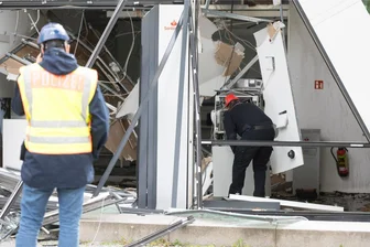 Wegen Sprengungen: Nächste Bank im Osten schließt nachts Zugänge zu Geldautomaten - Polizisten inspizieren eine Bankfiliale in Berlin, in der in der Nacht zu Montag ein Geldautomat gesprengt wurde. Durch die Explosion wurde die Bankfiliale erheblich beschädigt.