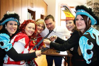 Weiberfasching: Schnittiger Start in den Karneval - Um das Ende seiner Krawatte mitzuerleben wurde Philipp Preißler vom Büro des Oberbürgermeisters von den Karnevalsdamen auch noch über den Tisch gezogen.