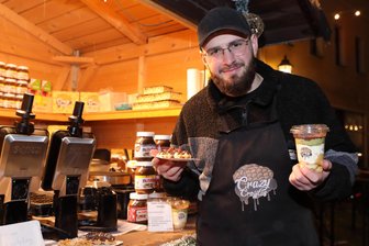 Weihnachtsmärkte im Erzgebirge überraschen mit diesen Leckereien: Von Gänse-Burger bis Dubai-Tiramisu - Albin Isufi, Mitarbeiter bei Crazy Croffles, hat auf dem Schwarzenberger Weihnachtsmarkt das Dubai-Schokolade-Tiramisu im Angebot.