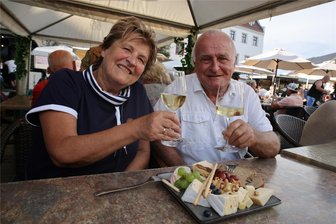 Weinfest Zwickau 2024: Das kosten Weine, Flammkuchen und Käseteller - Ilona Hielscher und Karl-Heinz Kunz lassen sich Wein und Käseteller schmecken.