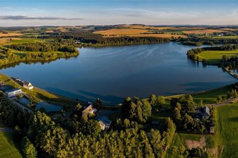 Welterbe-Haus in Großhartmannsdorf: Verkauf an Privatleute? - Der Untere Großhartmannsdorfer Teich aus der Luft fotografiert. Links im Bild: Das alte Teichhaus auf der Dammkrone.