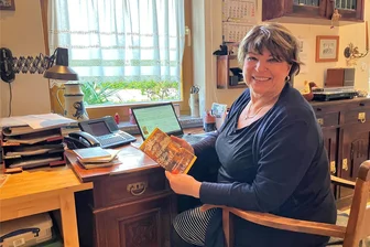 „Wenn dich am Morgen Stille weckt ...“: Hobby-Autorin aus dem Erzgebirge veröffentlicht Weihnachtsbuch - Iris Schürer an ihrem Arbeitsplatz im Büro ihres Hauses, in der Hand ihr jüngstes Werk „Wenn dich am Morgen Stille weckt...“.