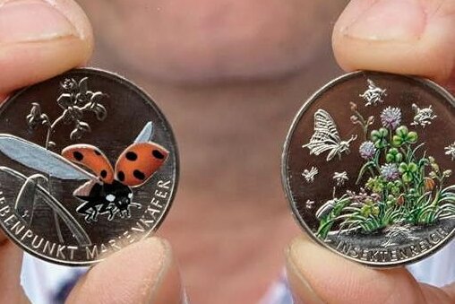 Wie bunte Münzen und Neuheiten Besucher auf Reichenbacher Münzbörse locken sollen - Andreas Keßler präsentiert die teilkolorierten 5-Euro-Münzen "Siebenpunkt-Marienkäfer" und "Insektenreich".