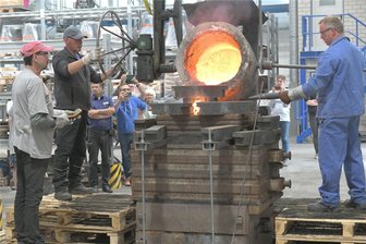 Wo in Freiberg noch Glocken gegossen werden - Holger König (links, auf dem Podest) und Sven Kunze beim Glockenguss im Sächsischen Metallwerk in Freiberg. Die fertige Glocke wird einen Durchmesser von 78 Zentimetern haben und fast 300 Kilogramm wiegen. Die Firma an der Zuger Straße gehört zu den wenigen Unternehmen in Deutschland, die noch Glocken gießen.